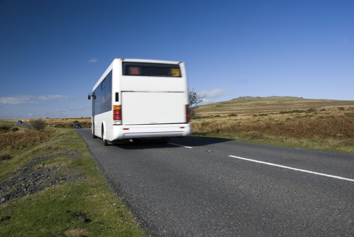 Blurred bus on rural road. Dartmoor, Devon, UK